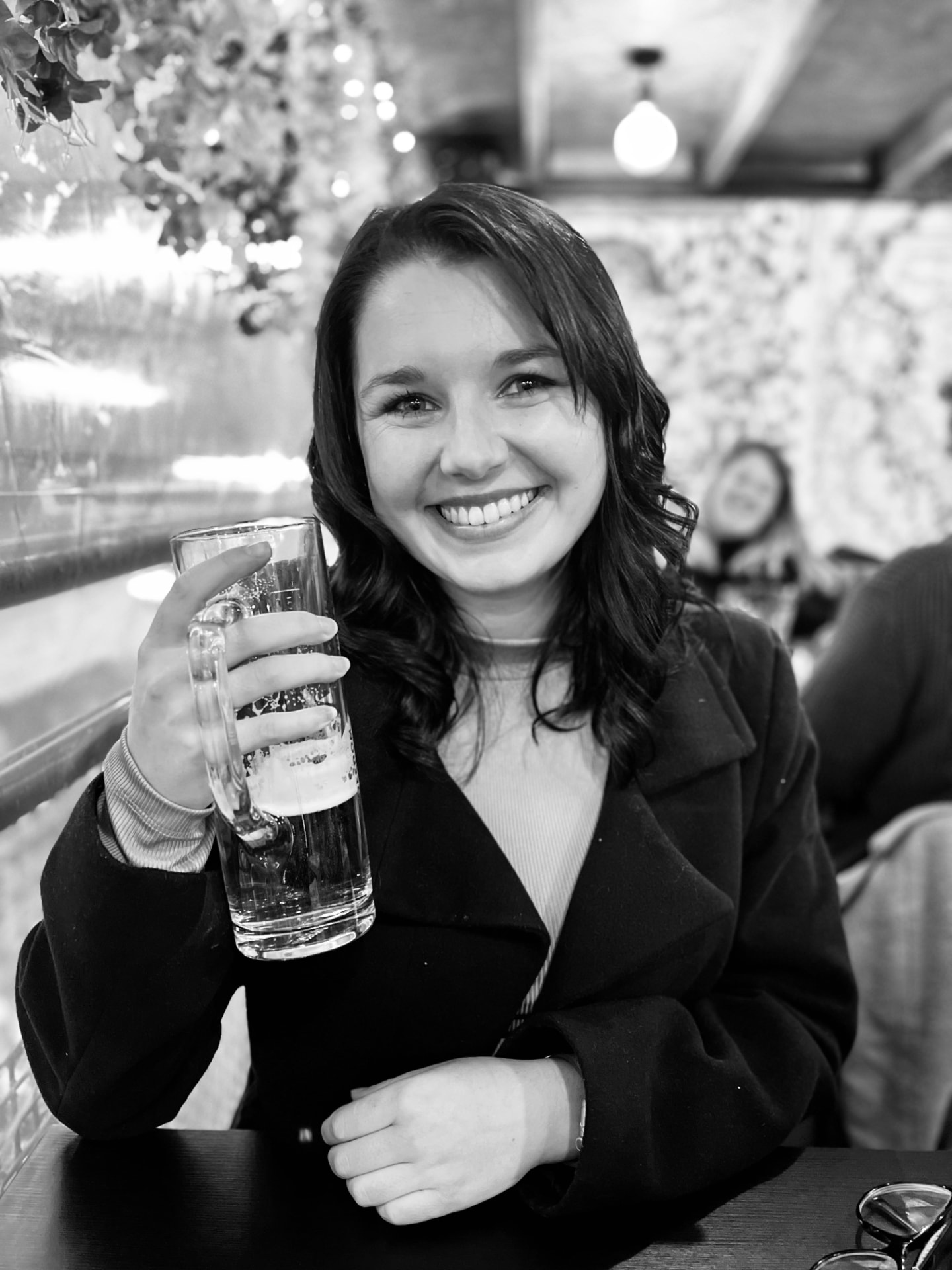 Gabi, the woman behind The Expattery, smiling in a pub